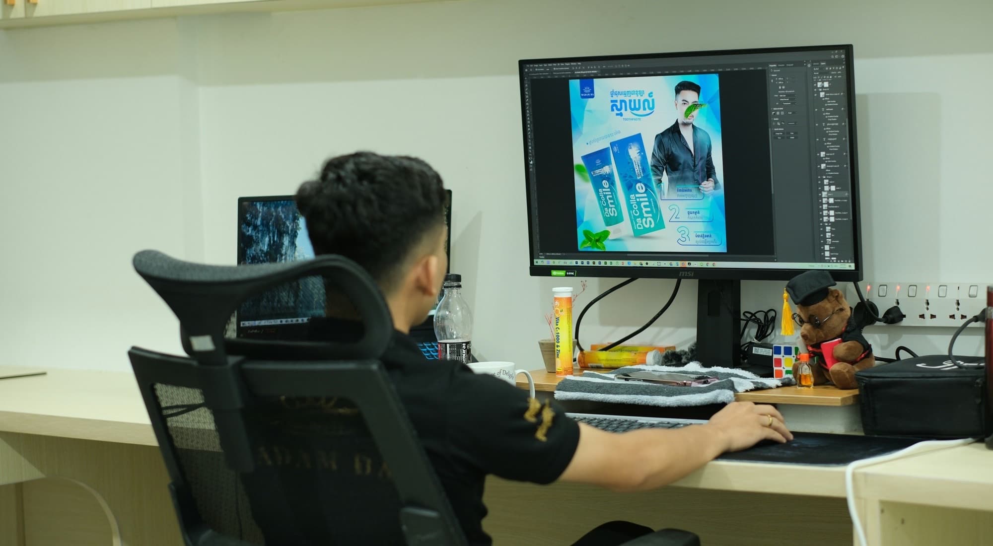 A designer working at a large screen